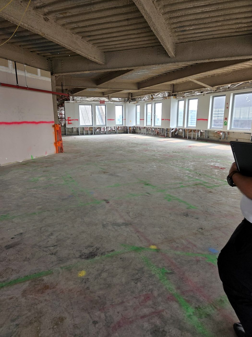 Open raw floor plate with layout marks before build-out